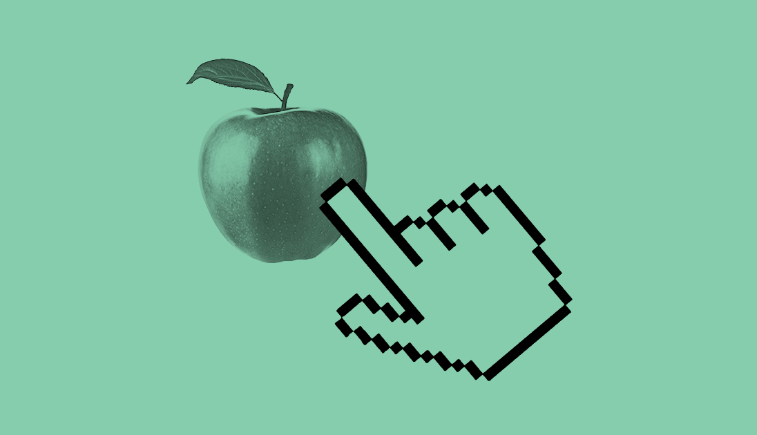 A hand pressing an apple